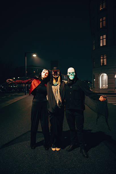 istock Three friends in creative costumes enjoying Halloween night in an urban setting 2237665298
