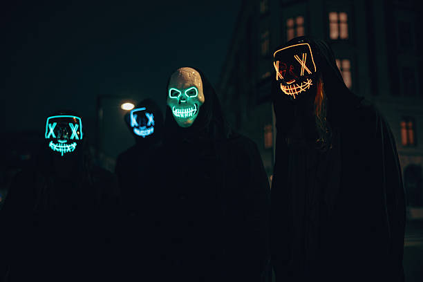 istock People with illuminated masks gathering outdoors at nighttime 2237665395