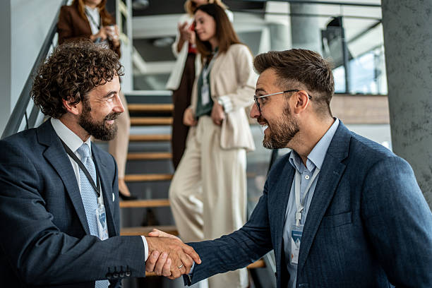 istock Businessmen shaking hands making agreement at meeting 2237665794