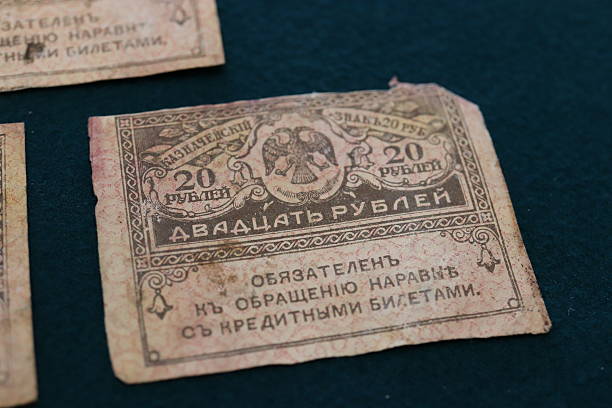istock An old 20 rubles banknote with faded colors and intricate designs, featuring a double-headed eagle emblem, on a dark background 2237667128