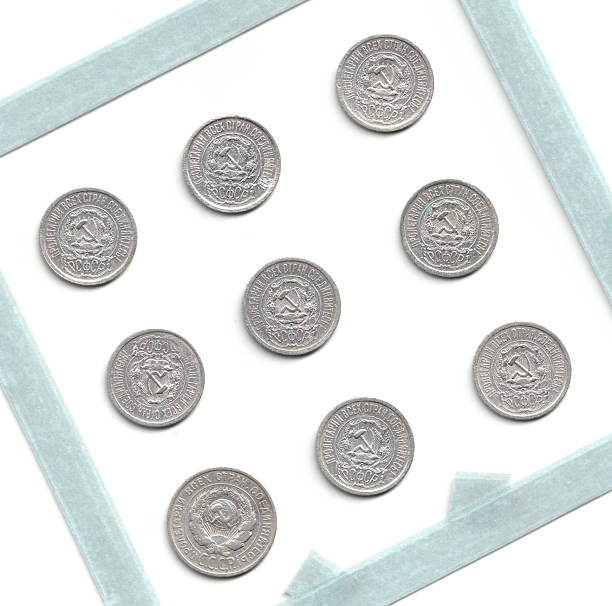 istock A collection of ten silver coins arranged in a square, featuring intricate designs and inscriptions, displayed on a light blue background 2237667436