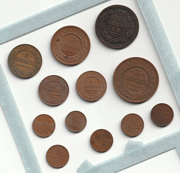 istock A collection of vintage coins arranged in a grid, featuring various sizes and designs, with a neutral background 2237667457