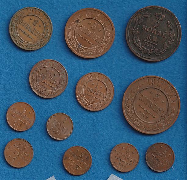 istock A collection of vintage coins displayed on a blue background, featuring various sizes and designs, some with inscriptions and decorative elements 2237667491