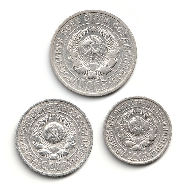 istock Three vintage Soviet coins featuring the hammer and sickle emblem, surrounded by a wreath, with inscriptions in Russian. 2237667524