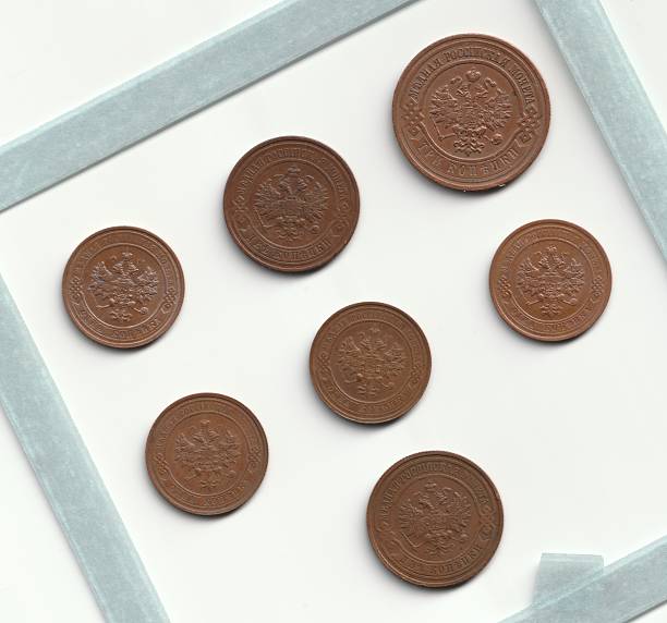 istock A collection of seven bronze coins arranged on a white background, featuring intricate designs and inscriptions 2237667558