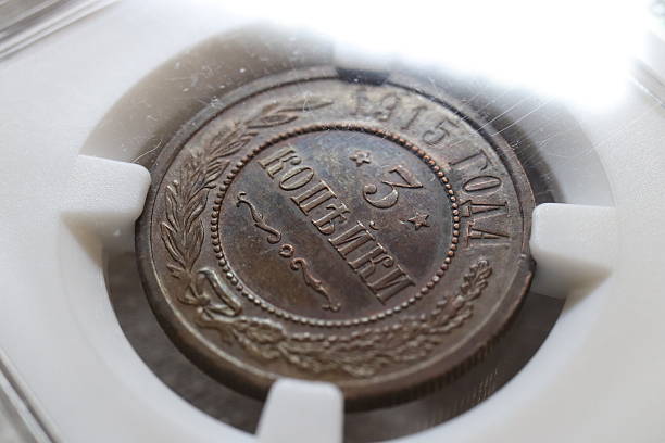 istock An antique coin displayed in a protective case, featuring inscriptions in Russian 3 kopecks, including the year 1815 and the denomination of 3 kopecks, surrounded by decorative elements 2237667742