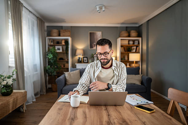 istock Man working from home with laptop in living room 2237673011