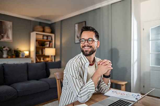 istock Happy man working from home smiling, looking away 2237673094