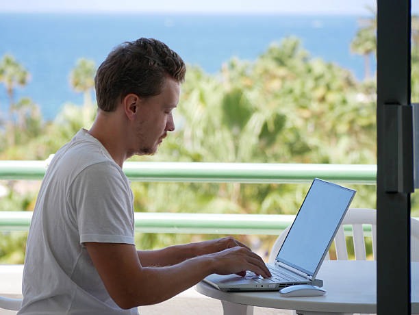 istock Remote Freelancer Typing on Laptop with Ocean View in Tropical Paradise 2237678792