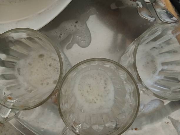 istock Glass mugs washed with liquid soap on a white silver metal tray 2237682199