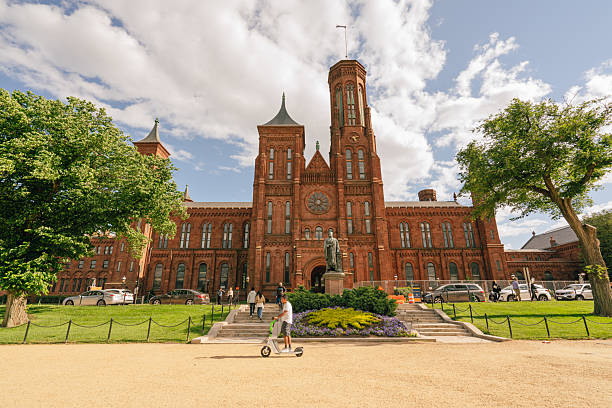 Washington D.C., USA - May 23, 2025. Historic Smithsonian Institution Building on a partly cloudy day.