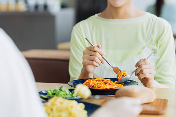 istock Young woman having lunch with friends at a restaurant 2237683447