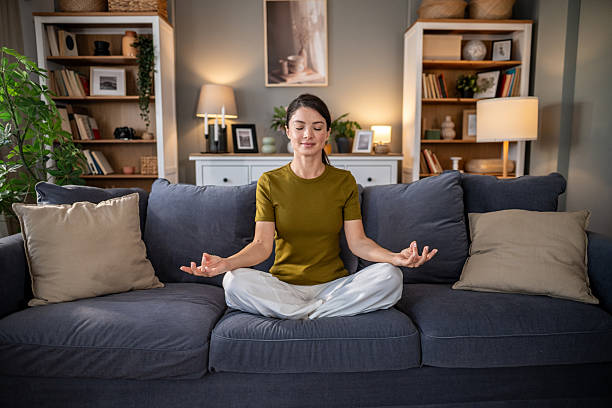 istock Woman meditating on sofa for mindfulness and relaxation 2237684407