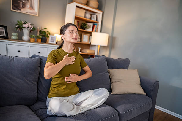 istock Woman practicing deep breathing meditation for stress relief at home 2237684432