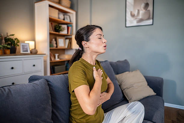 istock Woman practicing deep breathing exercise for relaxation at home 2237684440