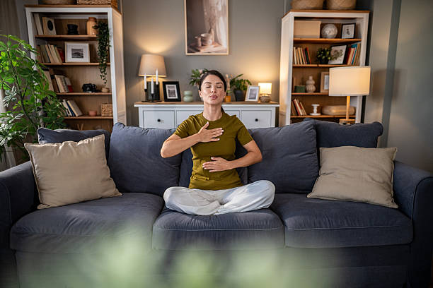istock Woman practicing deep breathing for mindfulness and relaxation at home 2237684467