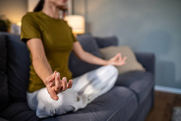 istock Woman meditating in lotus pose practicing mindfulness at home 2237684493