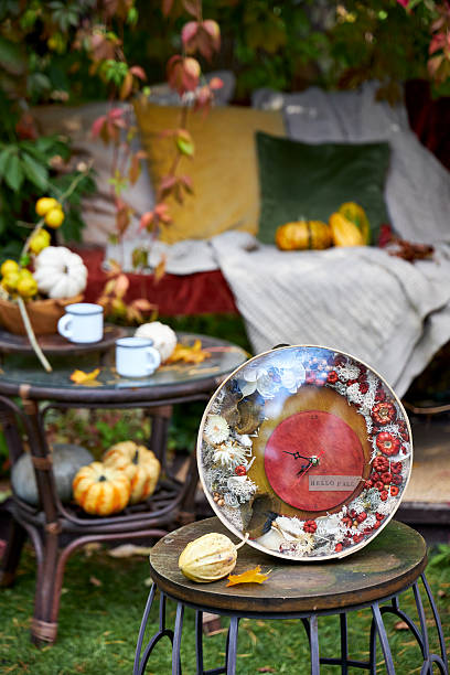 istock Handmade autumn wall clock decorated with dried flowers, moss and mini pumpkins. Rustic seasonal home decor with inscription Hello Fall, perfect for cozy fall interior or gift. 2237684838