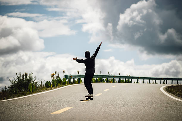 istock Skateboarder skateboarding on the mountain road 2237685583