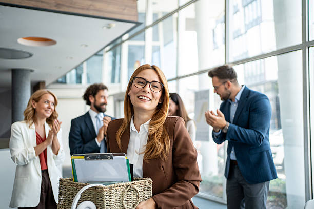 istock Businesswoman leaving office, colleagues clapping for new beginning 2237686139