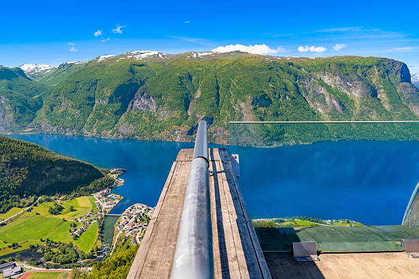 Stegastein lookout on the Aurlandsfjellet scenic route overlooking Aurlandsfjord near Aurland, Norway, with steep mountains and blue sky in summer