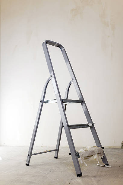 istock Metal ladder resting against a plain wall in an empty room under renovation 2237689620