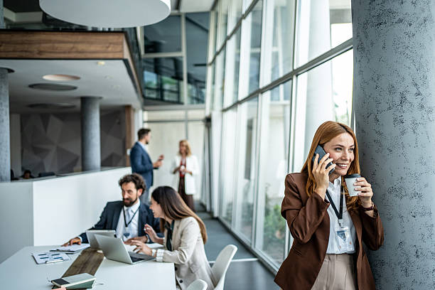 istock Businesswoman talking on phone during office coffee break 2237689752