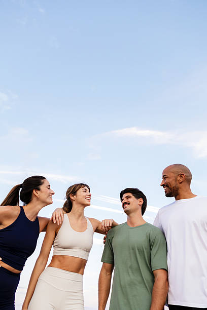 istock Group of diverse friends standing, talking, and smiling while exercising outdoors. Showing concepts of friendship, fitness, and togetherness 2237689793