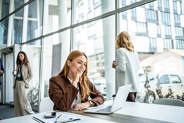 istock Businesswoman smiling while working on laptop in office 2237689935
