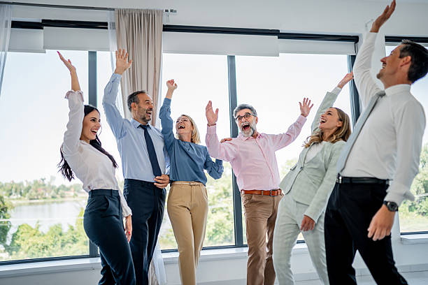 istock Cheering business people celebrating success in office 2237691600