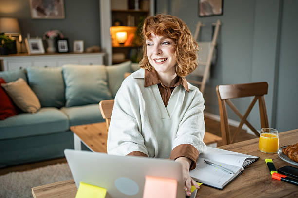 istock Young woman smiling working remotely from home 2237696189