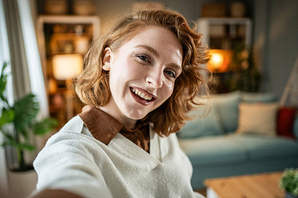 istock Young woman vlogging and smiling at home 2237696225