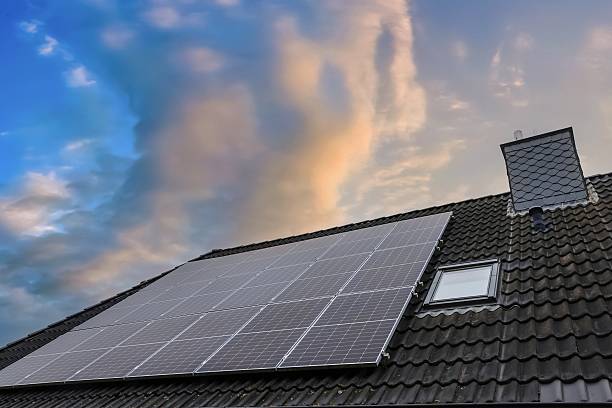istock Solar panels generating clean energy on house roof during sunset 2237697444