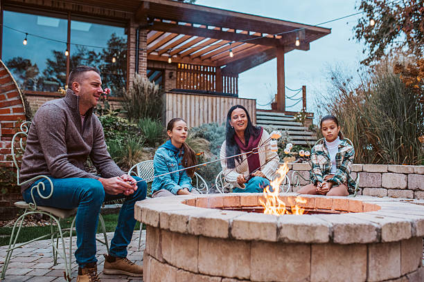 istock Family roasting marshmallows over open flame, campfire on backyard. 2237700139