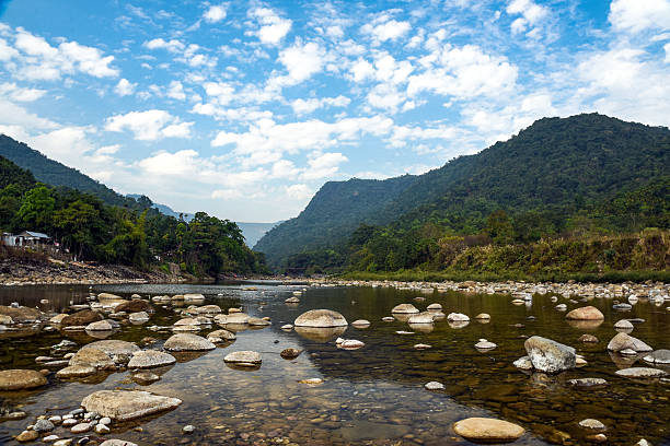istock Tranquil Mountain River Scene With Pebble Beach, Forest, and Distant Ranges 2237701743