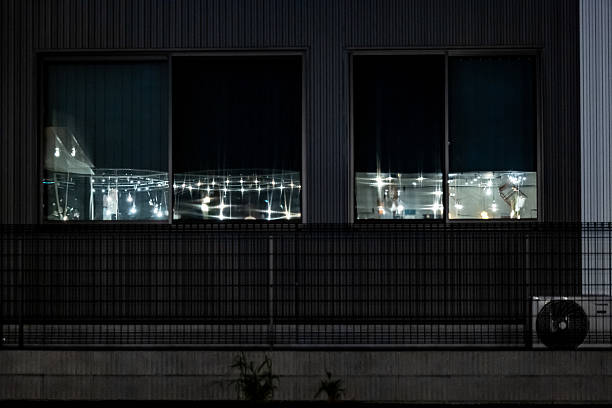 Reflection of shop lights on building  windows at night