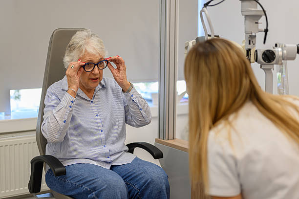 istock Senior woman holding eyeglasses and discussing her vision problems with female ophthalmologist during eye checkup 2237706962