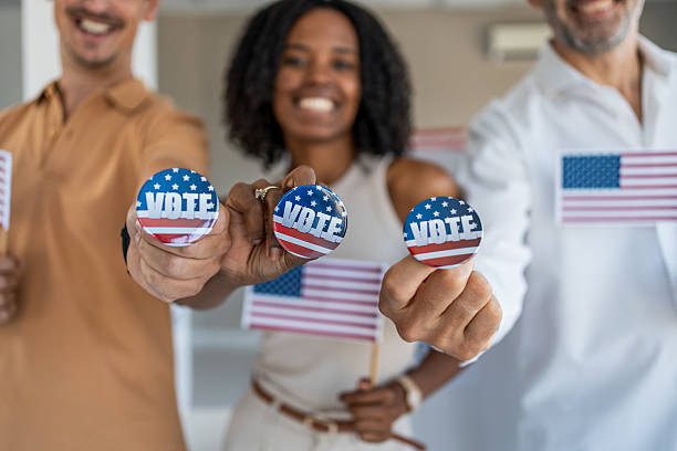 istock Diverse group of proud voters holding usa flags 2237709614