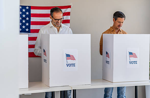 istock Men voting in polling place for us presidential election 2237709654