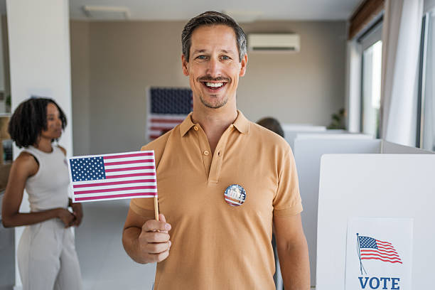 istock Man holding American flag voting in US election 2237709771