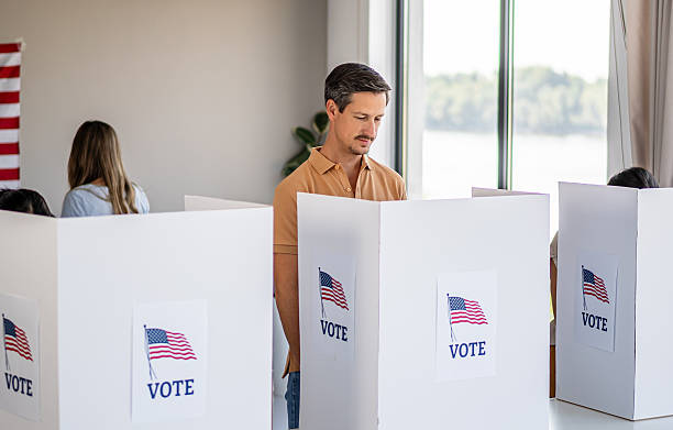 istock Man voting in booth at polling place 2237710745
