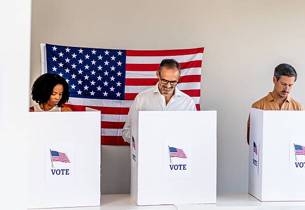 istock People voting in polling booth with American flag 2237710760