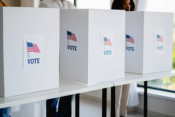 istock People voting in election polling station booths 2237710909