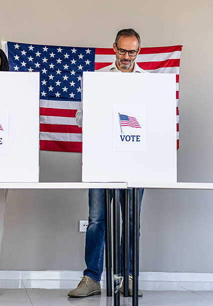 istock Man voting in booth at polling place 2237711195