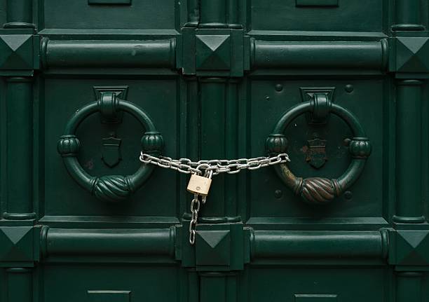 istock Locked green doors with chain and padlock as symbol of secucity and protection 2237712607