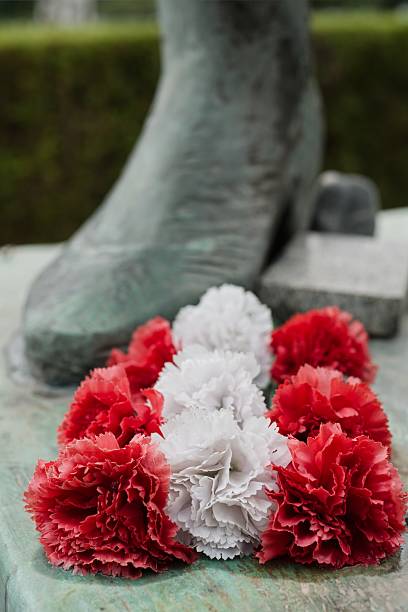 istock Red and white carnations placed at a monument as symbol of respect and remembrance 2237712672