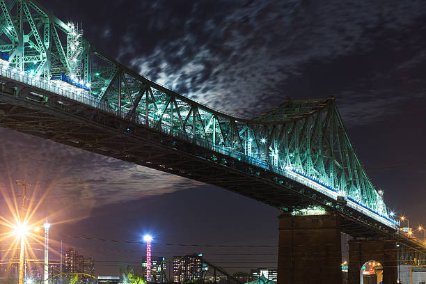 istock Nighttime Green Bridge Illuminated Over City Skyline With Dramatic Night Sky 2237713014