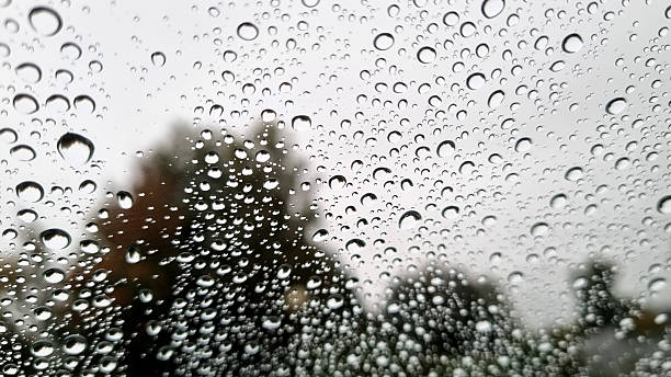 istock A sad landscape behind raindrops. Raindrops on glass close-up. Selective focus 2237715708