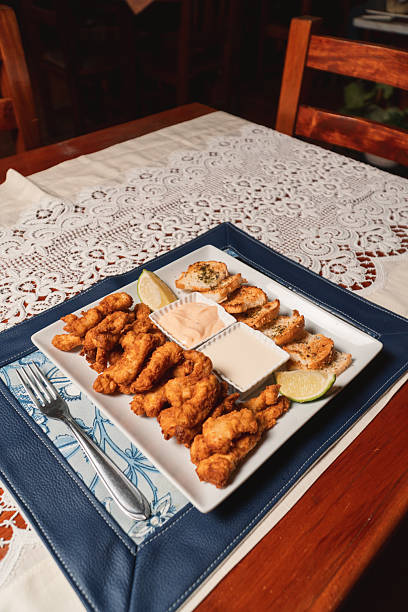 istock Small pizzas and breaded cutlets with sauces served on a plate. 2237717447