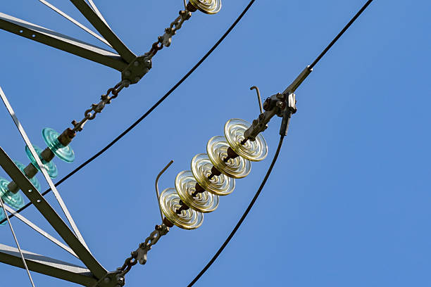 Close up view of the insulators on high voltage power lines on pylons which form the national electric grid and power supply system in the UK